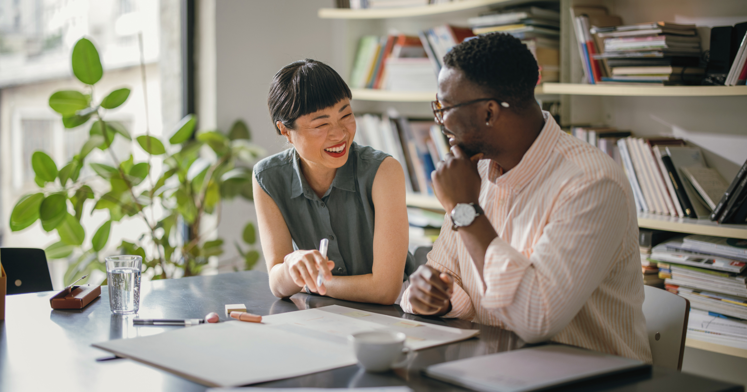 Man and woman smiling in a work setting